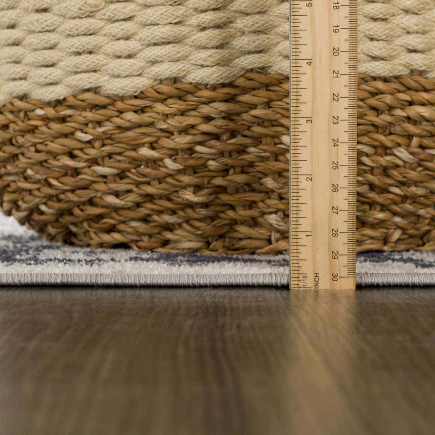 Close-up of the Cabacungan Cream & Gray Washable Area Rug showing the rug's edge, gray pattern, and texture. Pile
