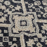 Close-up of the detailed, traditional pattern on the Cabacungan Cream & Gray Washable Area Rug. Texture