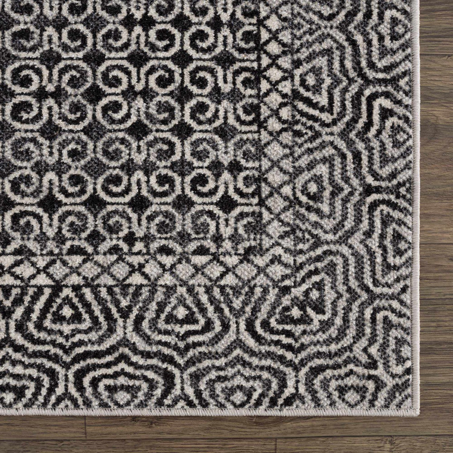 Close up of the Coledale Black & White Washable Rug showing its geometric, farmhouse-style pattern and soft texture. Swatch