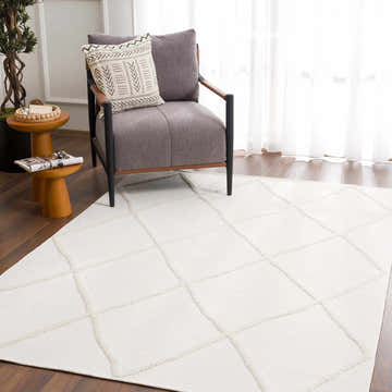 Living room scene with a gray chair on an Amani White Washable Rug. Geometric pattern, contemporary style. Roomscene-Rectangle