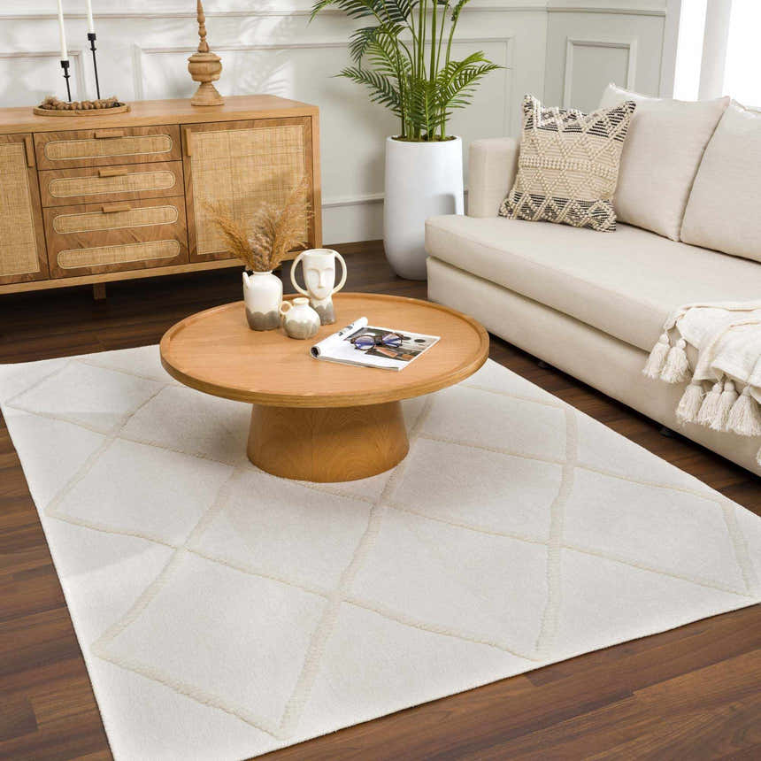Living room scene with a light wood coffee table over the Amani White Washable Rug, creating a cozy, neutral space. Roomscene-Rectangle