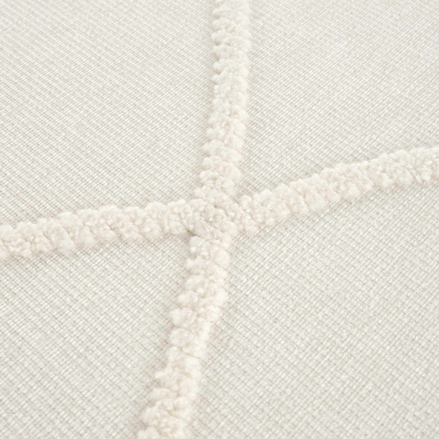 Close up of the Amani White Washable Rug, showing the geometric pattern and soft, textured design. Texture
