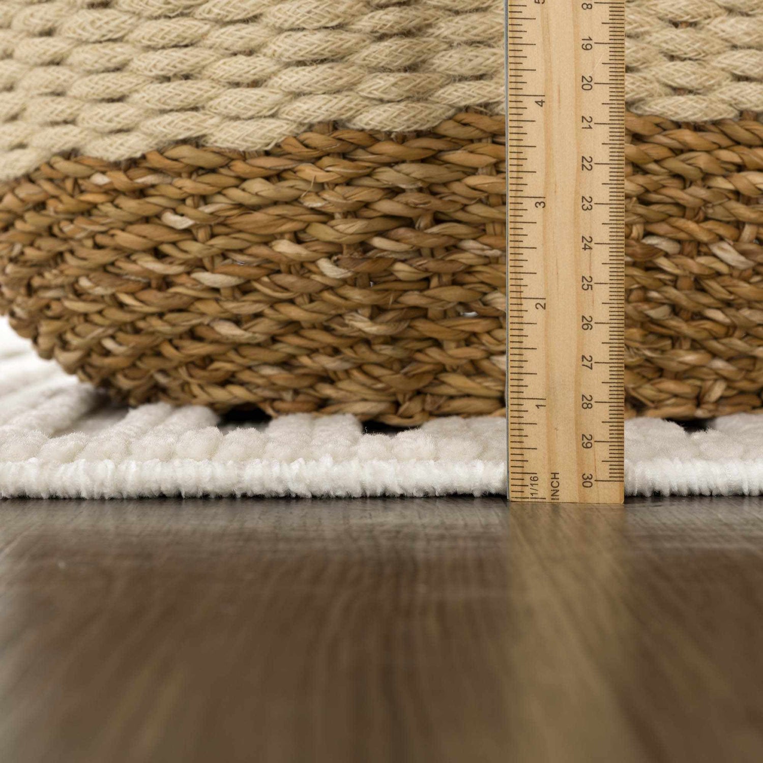 Close-up of the plush, off-white pile height of the Deron White Washable 3D Rug with a ruler for scale. Pile