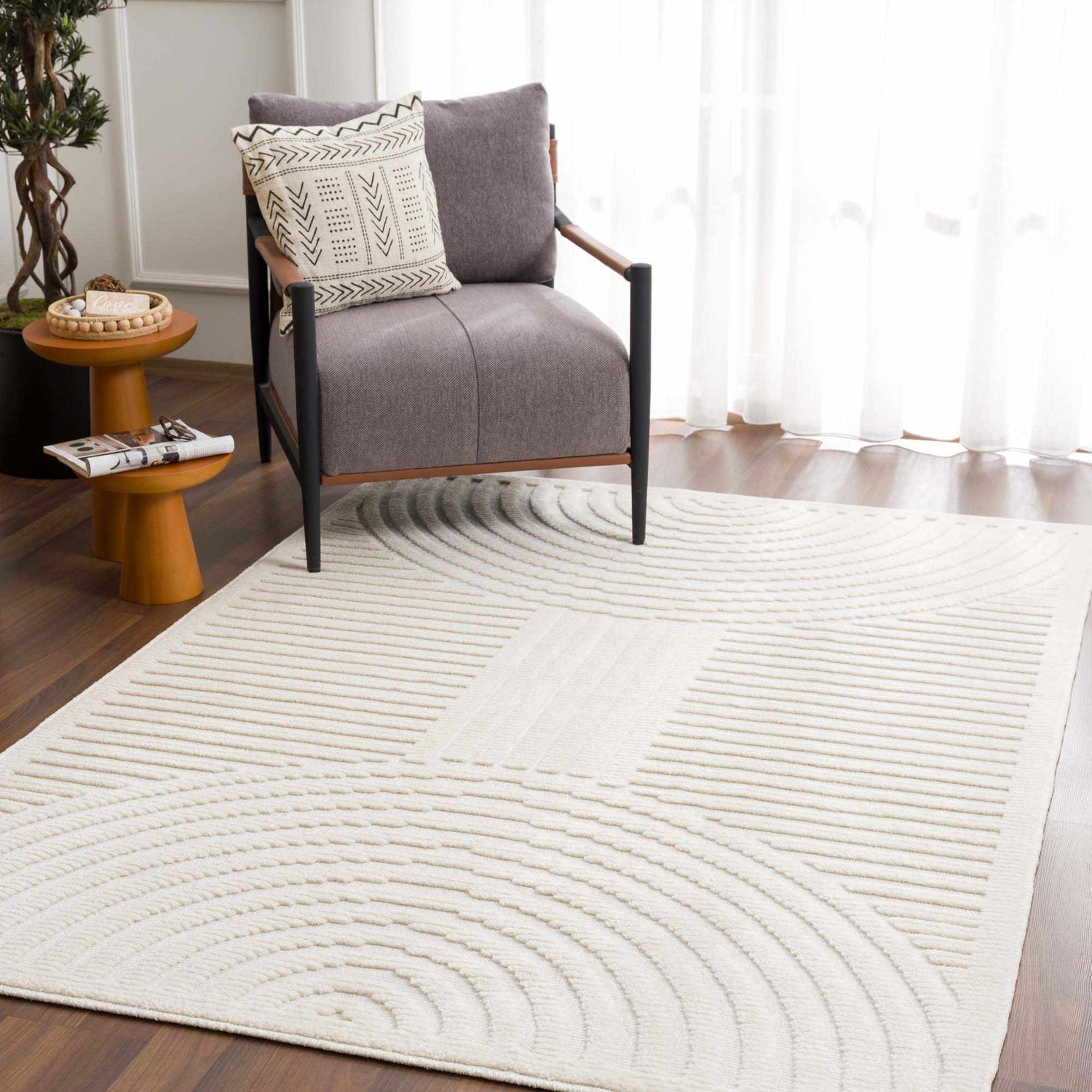 Living room scene with a Deron White Washable 3D Rug, gray chair, wood side tables, and modern geometric decor. Roomscene-Rectangle