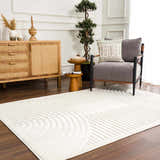Living room scene with a white Deron Washable 3D Rug, gray chair, wood cabinet, and dark wood floors. Roomscene-Rectangle