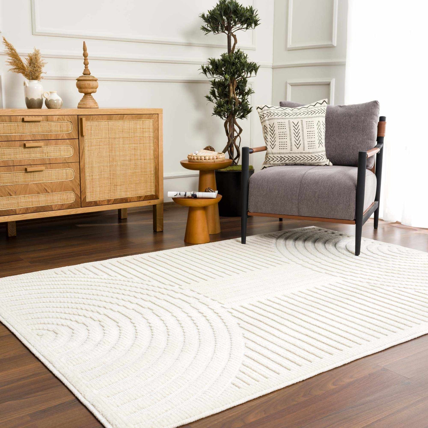 Living room scene with a white Deron Washable 3D Rug, gray chair, wood cabinet, and dark wood floors. Roomscene-Rectangle