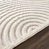 Close-up of the Off White Deron Washable 3D Rug showing its geometric, raised-texture, semi-circle pattern. Pile