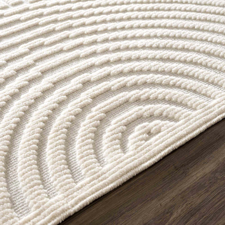 Close-up of the Off White Deron Washable 3D Rug showing its geometric, raised-texture, semi-circle pattern. Pile