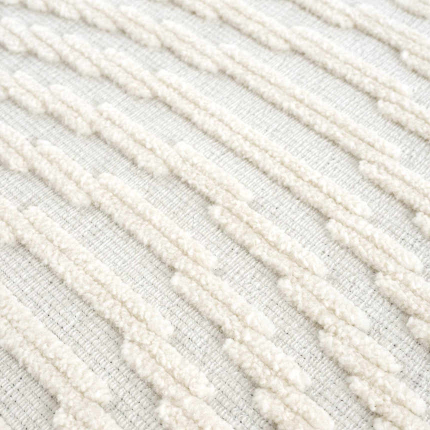 Close-up of the Deron White Washable 3D Rug showing its geometric, textured design and off-white color. Texture