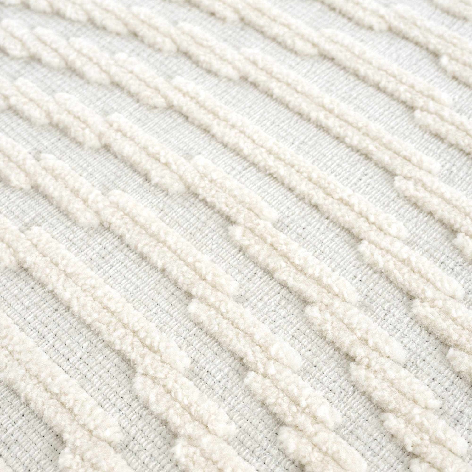 Close-up of the Deron White Washable 3D Rug showing its geometric, textured design and off-white color. Texture
