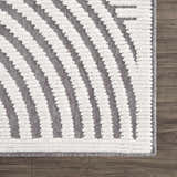 Close up of the Deron Gray Rainbow Washable Rug. Features a geometric pattern with gray and textured white stripes. Swatch