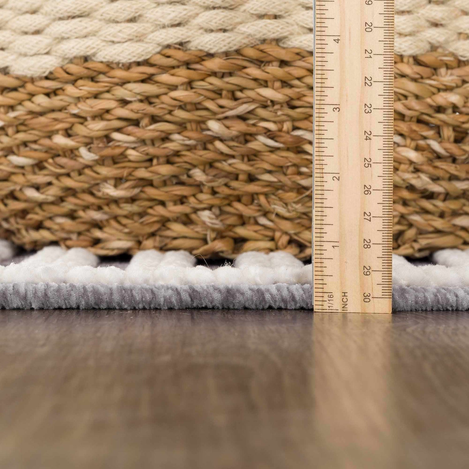 Close-up of the gray Deron Gray Rainbow Washable Rug showing texture and pile height with a ruler for scale. Pile