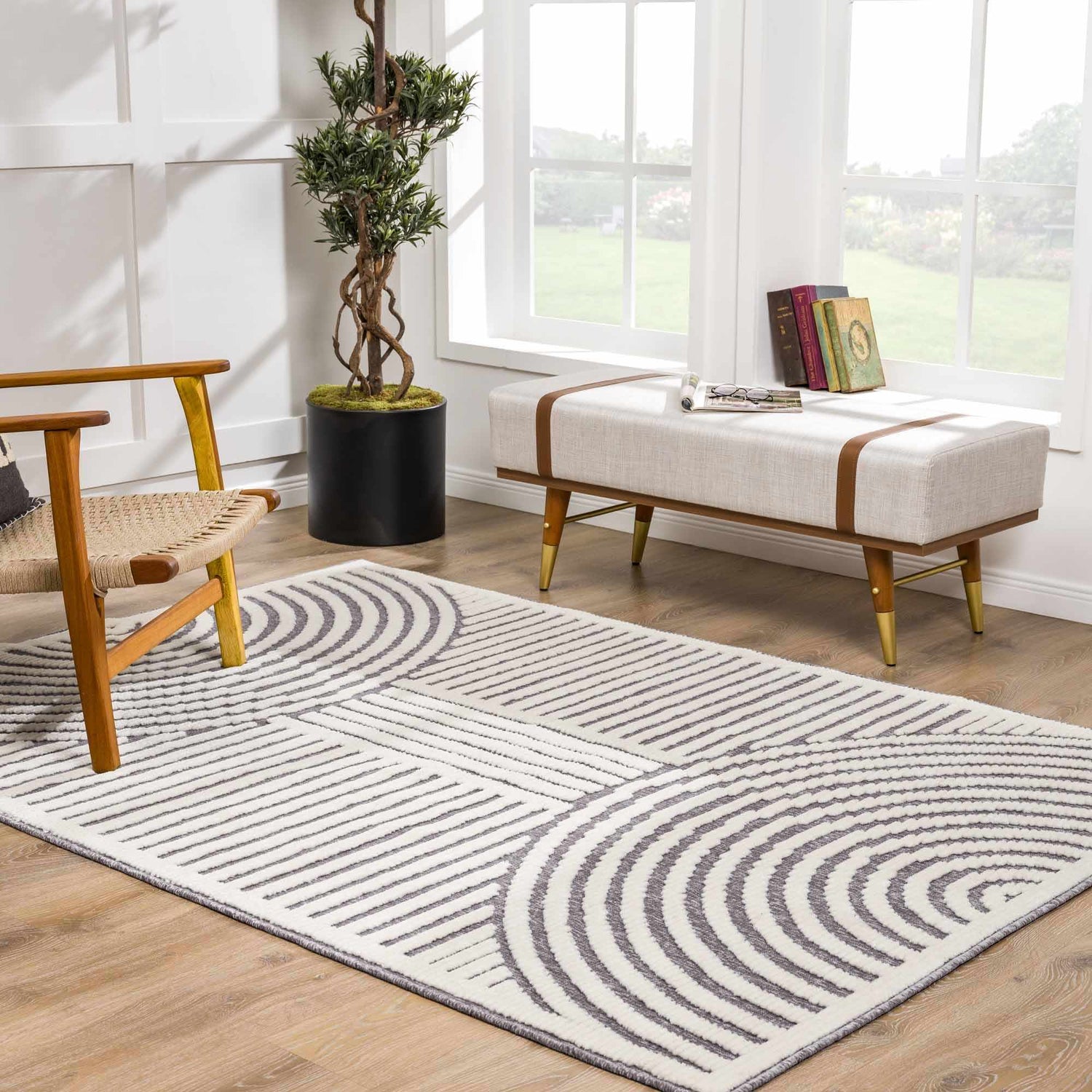 Bright living room with geometric Deron Gray Rainbow Washable Rug, wood chair, and bench near window. Roomscene-Rectangle