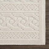 Close up of the Fadey White 3D Washable Rug showing geometric pattern and soft, textured pile on dark wood floor. Swatch