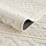 Close-up of the Fadey White 3D Washable Rug, showing the geometric pattern and plush, textured pile. Fold
