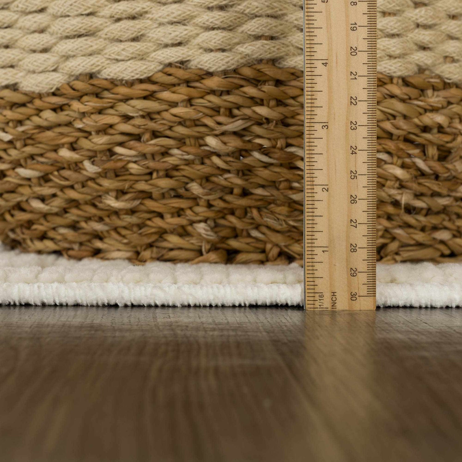 Close-up of the Fadey White 3D Washable Rug showing the texture and pile height with a ruler for scale. Pile