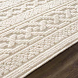 Close-up of the Fadey White 3D Washable Rug showing its geometric pattern and textured, off-white pile. Pile