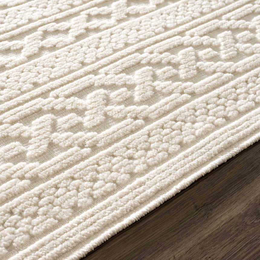 Close-up of the Fadey White 3D Washable Rug showing its geometric pattern and textured, off-white pile. Pile