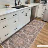 Kitchen scene with a Lagangilang Washable Area Rug runner in beige, camel, and charcoal colors on hardwood floors. Roomscene-Runner