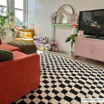 Eclectic living room with orange sofa and Lajos Black & White Checkered Plush Rug. Playful, modern style. Roomscene-Rectangle
