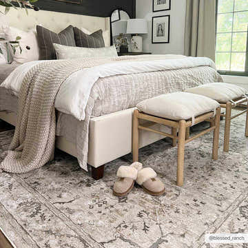 Bedroom scene with a neutral palette featuring the Laughlin Thick Luxe Boutique Rug in beige and gray tones. Roomscene-Rectangle