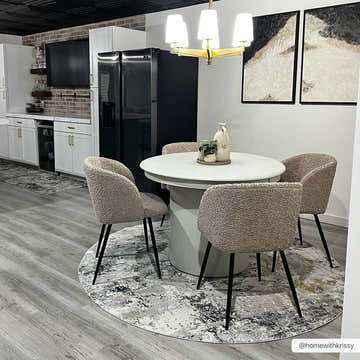 Modern dining room with round table on Lenzburg Faux Silk Abstract Rug in charcoal, gray, and mustard tones. Roomscene-Rectangle