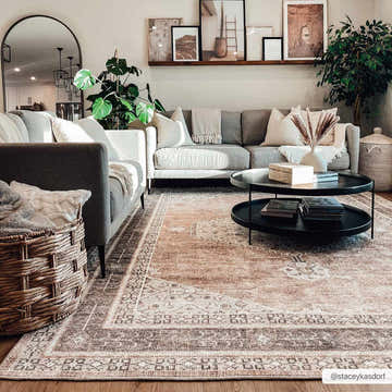 Living room with gray sofas, black coffee table, and tan Lila Medallion area rug, creating a warm, inviting farmhouse style. Roomscene-Rectangle