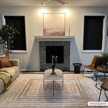 Living room scene with a beige and charcoal Lunao Area Rug, fireplace, and modern furniture. Roomscene-Rectangle