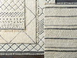 Close-up of Yoogali 3D Wool Rug showing geometric patterns, tassels, and hand-knotted texture in ivory and black. Styleshot