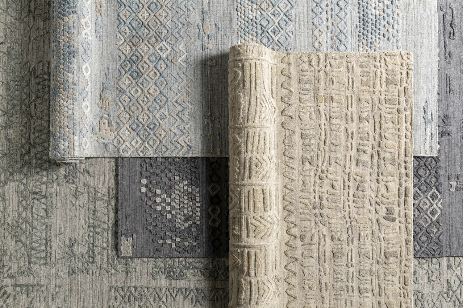 Close-up of Ensley Premium Rug in dusty sage, light & medium gray, pale blue, and tan. Hand-loomed farmhouse, Persian, transitional style. Styleshot