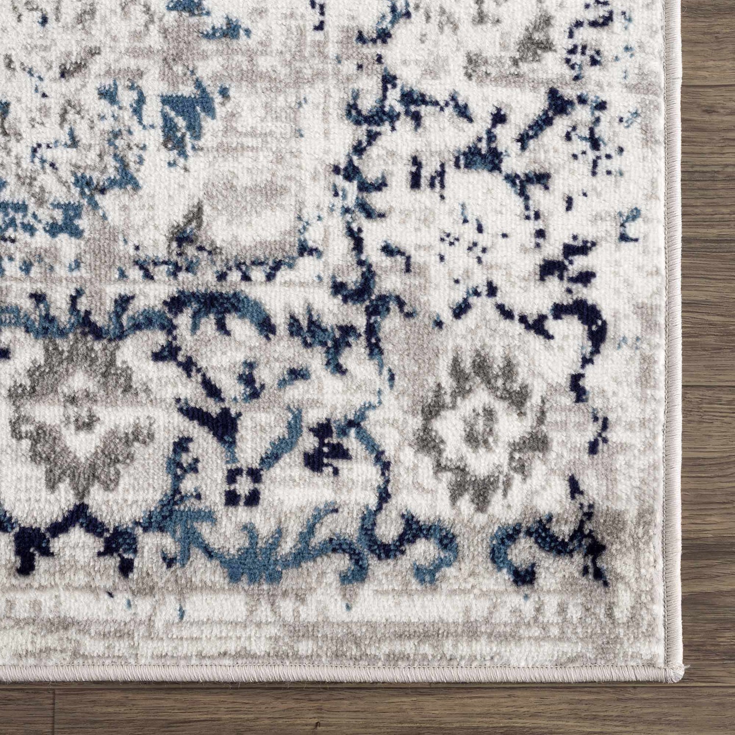 Close up of Duena Area Rug showing blue and gray traditional vintage pattern. Swatch