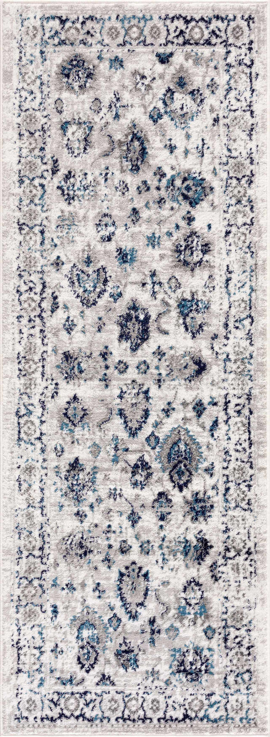Close-up of the Duena Area Rug. Blue and light gray traditional vintage pattern, machine woven polypropylene. Design-Runner