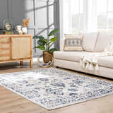 Living room scene with a blue and light gray Duena Area Rug, white sofa, and wood cabinet. Roomscene-Rectangle