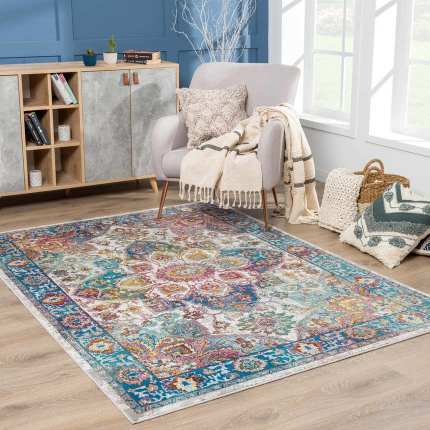 Living room scene with a colorful Mardin area rug, gray armchair, and wood cabinet. Roomscene-Rectangle