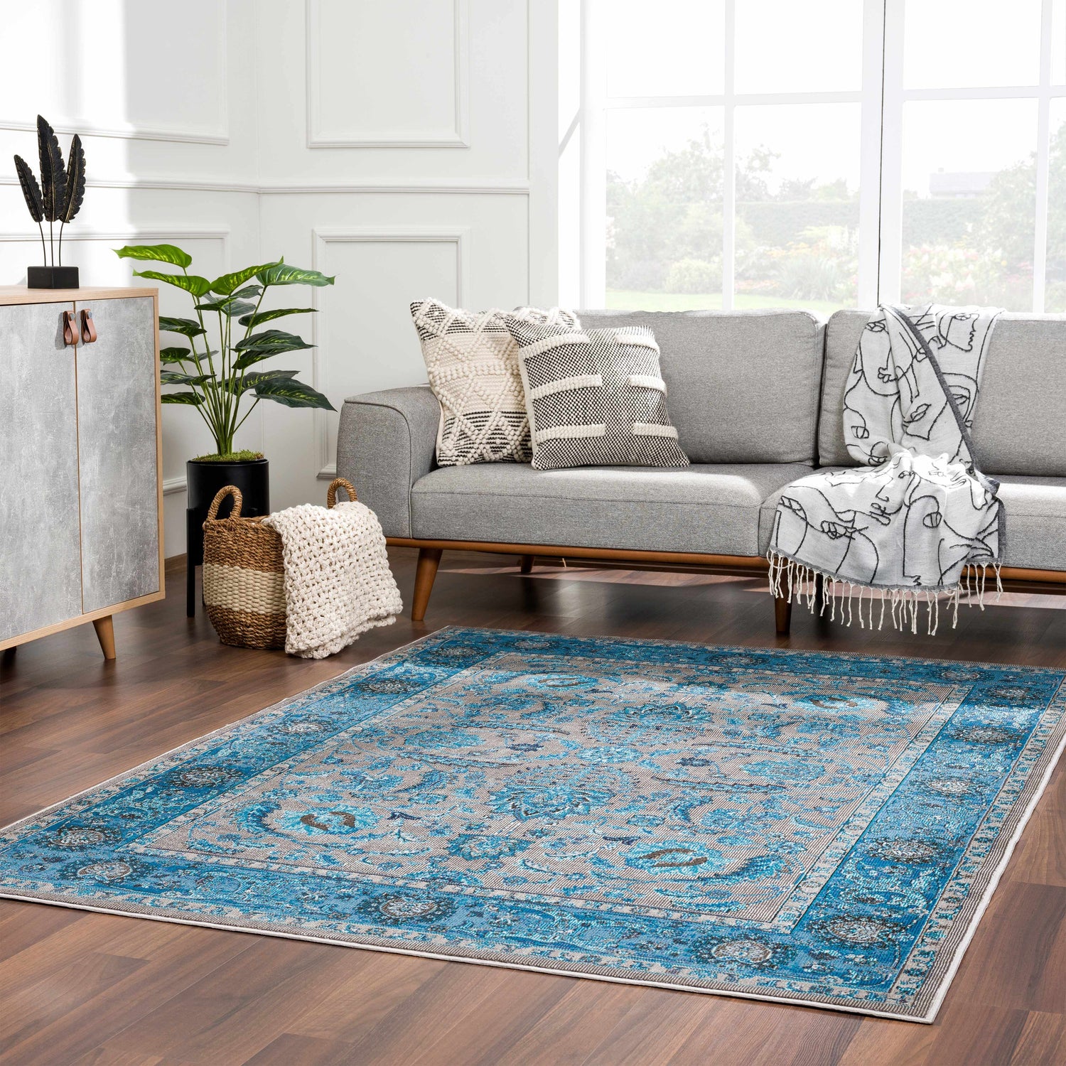Living room with a Mardina Turquoise Area Rug, gray sofa, and modern decor. Roomscene-Rectangle