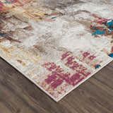 Close-up of the Mardin Abstract Area Rug showing its colorful abstract pattern with blue, pink, and mustard accents. Corner