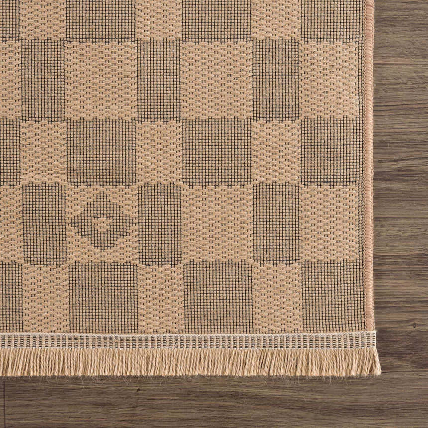 Close-up of a Nairi Checkered Washable Jute Rug. Beige and black checkered pattern with jute texture and fringe detail. Swatch