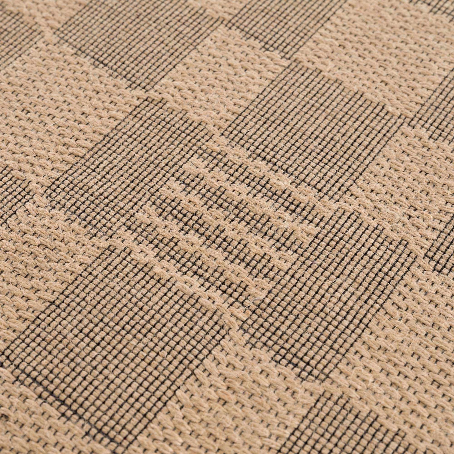 Close-up of the beige and black checkered pattern on the Nairi Checkered Washable Jute Rug. Jute texture visible. Texture