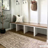Farmhouse mudroom with Marlene Medallion Brown Area Rug, white bench, wood floors, and neutral decor. Roomscene-Runner