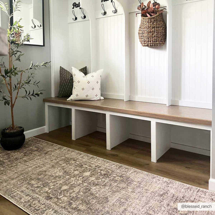 Farmhouse mudroom with Marlene Medallion Brown Area Rug, white bench, wood floors, and neutral decor. Roomscene-Runner