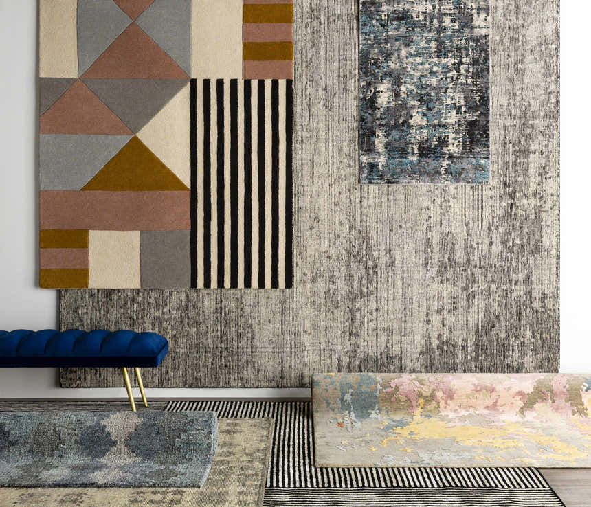 Display of various rug patterns and textures, including the Coorparoo Wool Area Rug with geometric shapes and stripes. Styleshot