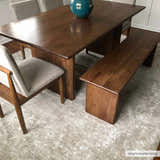 Dining room scene with wood table, bench, and gray chairs on a Monto Luxe Rug in cream and gray. Styleshot