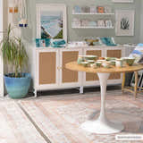 Styled room scene with a blush-toned Moora Washable Area Rug, white cabinet, round table, and decorative pottery. Roomscene-Rectangle