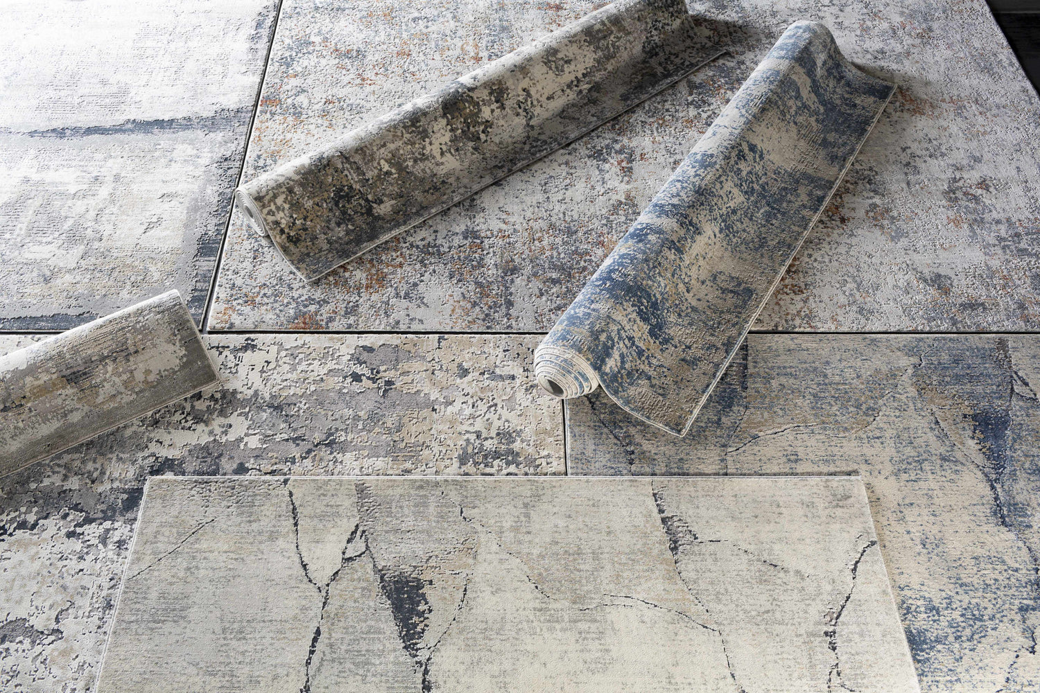 Close-up of the Gasquet Gray Marble Textured Luxe Rug, showing charcoal, blue, and gray abstract marble-like design. Styleshot