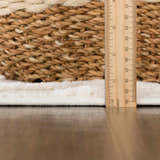 Close-up of the plush, bone-colored Gyundyukoru Area Rug showing its texture and pile height with a ruler for scale. Pile