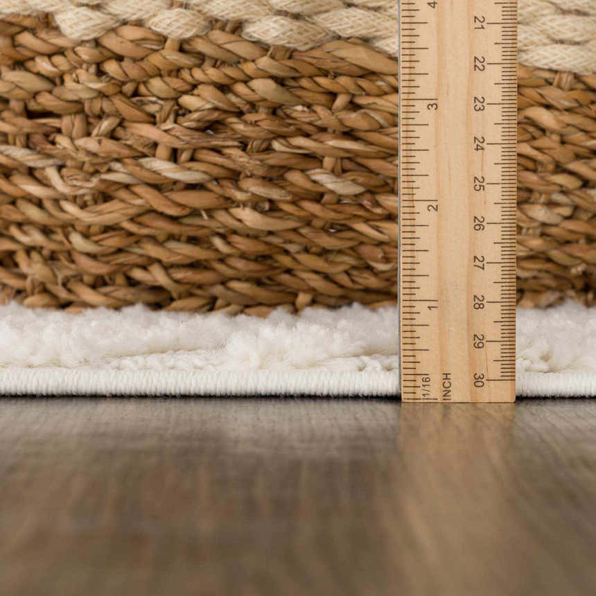 Close-up of the plush texture and pile height of the Manyas 3D Bone Area Rug, measured with a ruler. Pile