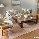 Living room scene with a light sofa and the Naja Washable Area Rug in a tan color with a geometric pattern. Roomscene-Rectangle