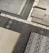 Close-up of Tamayong Tasseled Jute&Wool Rug. Features black, cream, and ink blue colors with geometric and striped patterns. Styleshot