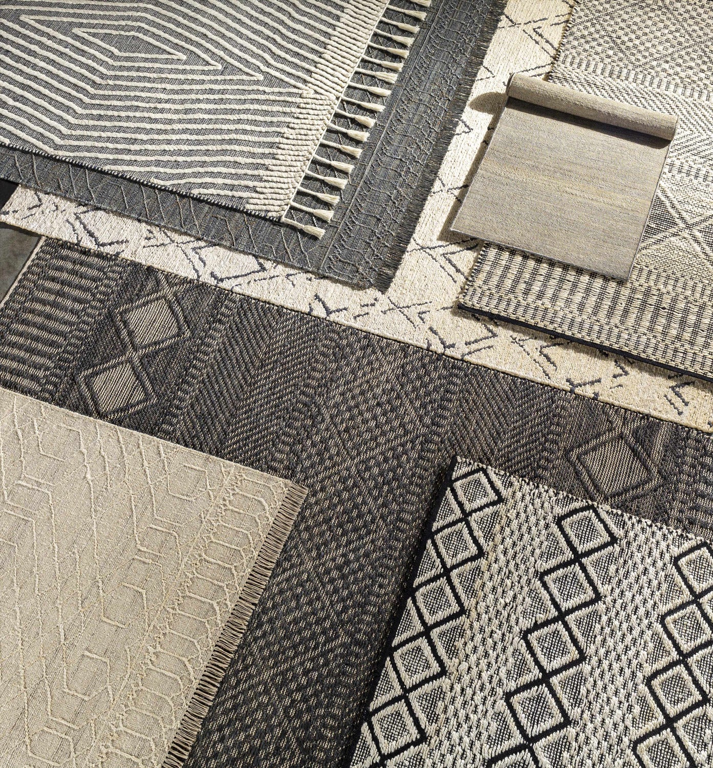 Close-up of Tamayong Tasseled Jute&Wool Rug. Features black, cream, and ink blue colors with geometric and striped patterns. Styleshot