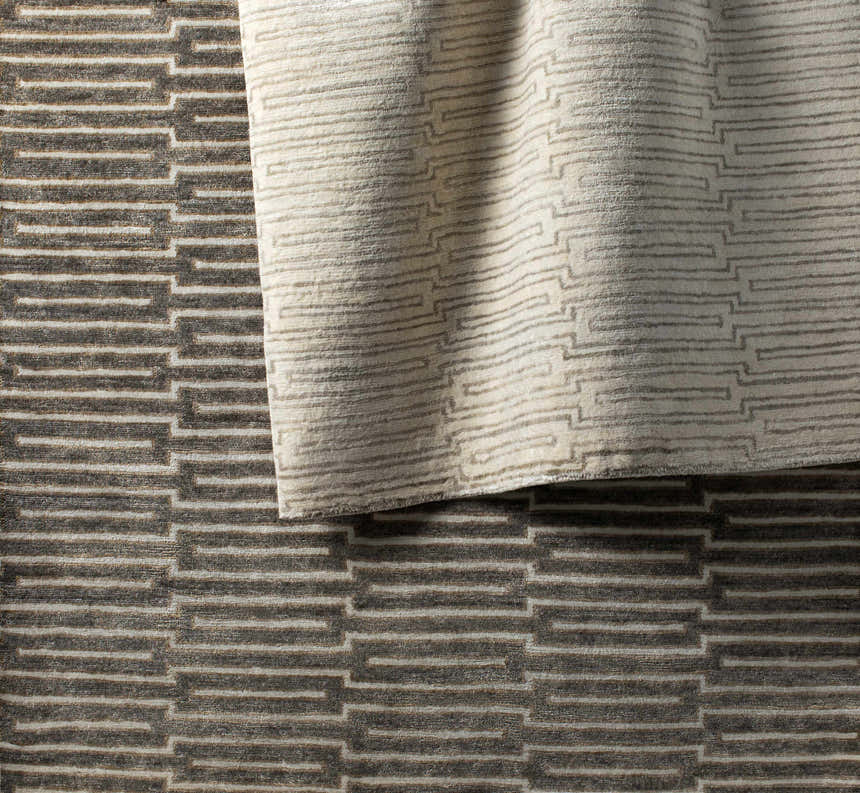 Close-up of the hand-knotted Partlow Area Rug. Beige and cream viscose rug with a contemporary geometric pattern. Styleshot